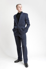Obraz na płótnie Canvas Thinking Stylish Caucasian Man in Made to Order Suit. Posing Aga