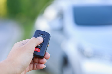 Woman hand holding key of new car