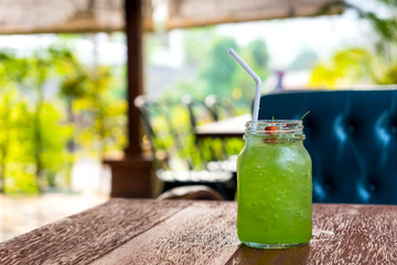 Green kiwi iced beverage on wooden table