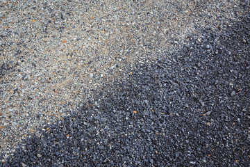 Texture black pebble stone on the road in Thailand