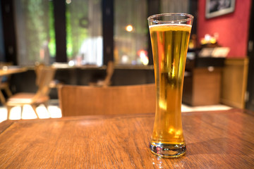 Beer in beautiful glass on brown table