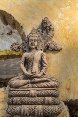 the ancient  buddha  statue sitting under sunlight