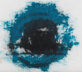 blue-black stain from paint on white material