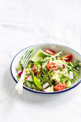 fresh salad with cherry tomatoes, arugula, radish and cucumber