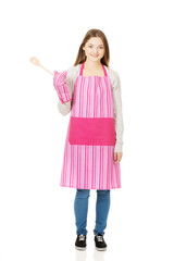 Happy teen woman wearing kitchen apron.