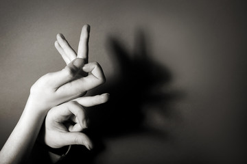 Hands gesture like hare on gray background - Powered by Adobe