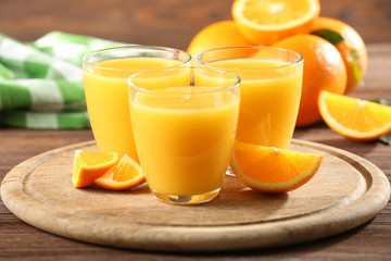 Orange juice on table on wooden background