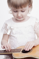 Fototapeta na wymiar funny little girl with guitar