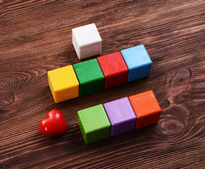 Colorful cubes for inscriptions on wooden background