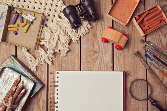 Website header design with notebook and creative vintage objects. View from above