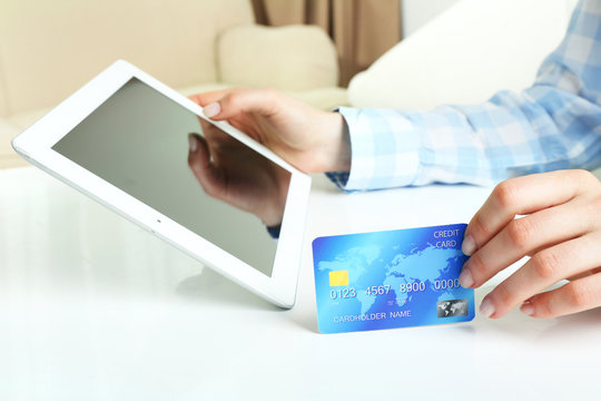 Female hands with tablet and credit card as online shopping concept