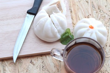 steamed pork buns, chinese dim sum and hot tea