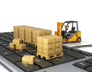 Concept of delivering, shipping or logistics. Forklift on keyboard.