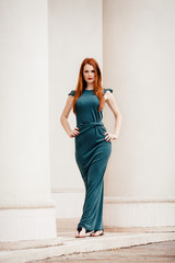 Outdoor portrait of beautiful redhead young woman