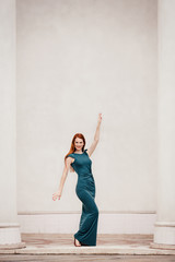 Outdoor portrait of beautiful redhead young woman