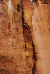 Ocher cliffs in Roussillon, France. Close up. Vertical. Copy space.