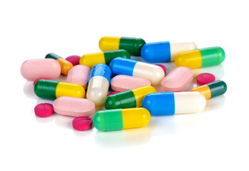 Obraz na płótnie Canvas Colored pills, tablets and capsules on a white background