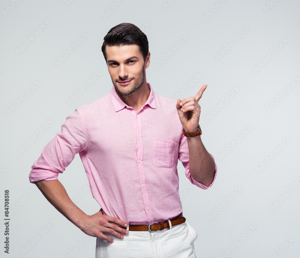 Poster Confident businessman pointing finger away