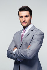 Confident businessman with arms folded