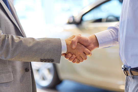 close up of male handshake in auto show or salon