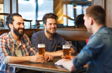 happy male friends drinking beer at bar or pub
