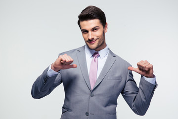 Happy businessman pointing at herself