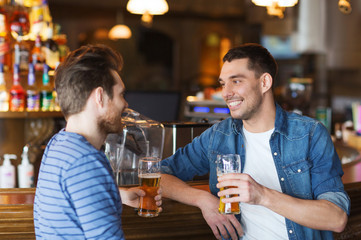 happy male friends drinking beer at bar or pub