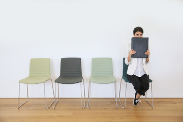 Woman in waiting room for job interview being anxious