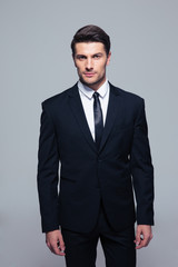 Handsome young businessman looking at camera