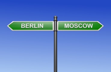 Fototapeta premium Signpost with arrows pointing two directions - towards Berlin and Moscow.