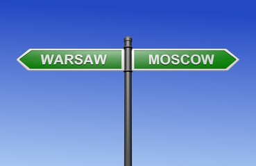 Fototapeta premium Signpost with arrows pointing two directions - towards Warsaw and Moscow.