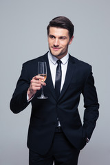 Happy businessman holding glass of champagne
