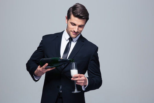 Businessman celebrating success, pouring champagne