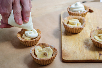 Little homemade oat tarts with whipped cream