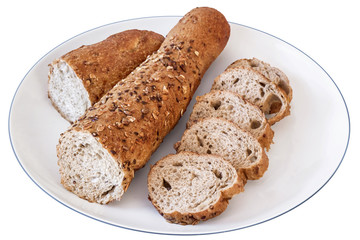 Baguette Integral Brown Bread Cut In Slices On White Plate Isolated.