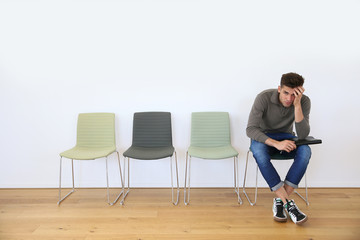 Young man in waiting room for job interview
