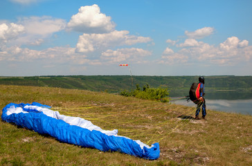 Paraglider prepares to fly over beautiful Bakota reservoir.