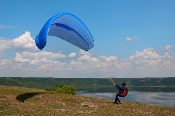 Paraglider prepares to fly over beautiful Bakota reservoir.