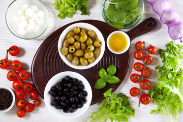 ingredients for a green summer salad. black and green olives. mo