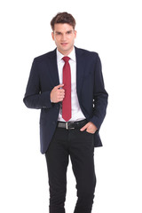 young business man holding his hand in pocket.