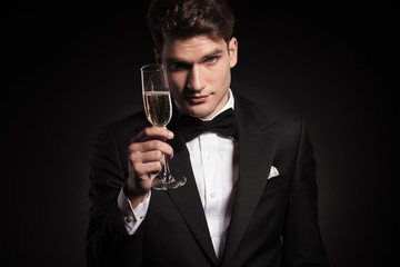  man offering you a glass of champagne.