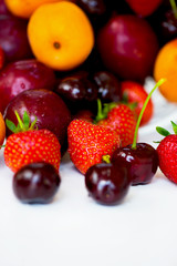 Obraz na płótnie Canvas Summer Berries and Fruits cherries, strawberries, plums, apricot