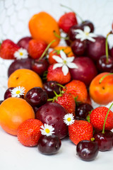 Fototapeta na wymiar Summer Berries and Fruits cherries, strawberries, plums, apricot