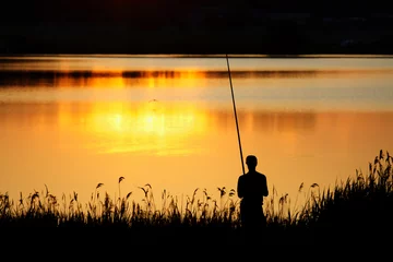 Foto op Plexiglas Man fishing at sunset © eugenegg