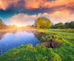 Fotobehang Colorful summer sunrise on the lake © Andrew Mayovskyy