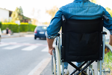 Disabled man preparing to go across the road