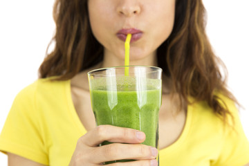 Close up of woman drinking green vegetable smoothie