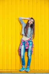 Beautiful Bool Girl over Yellow Wall