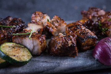 Close view on grilled crispy pork belly with sticky glaze
