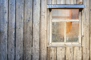 Wooden background. Wall of a barn with a window
